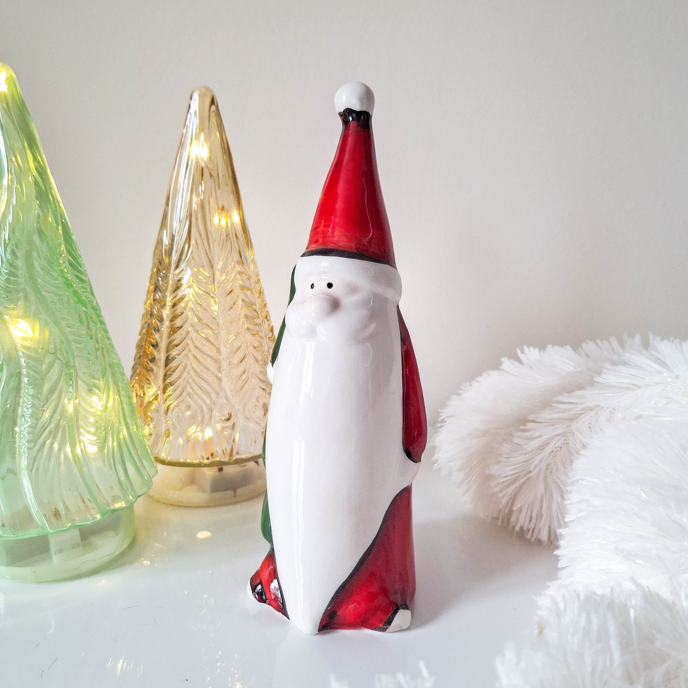 Red Santa Holding Christmas Tree