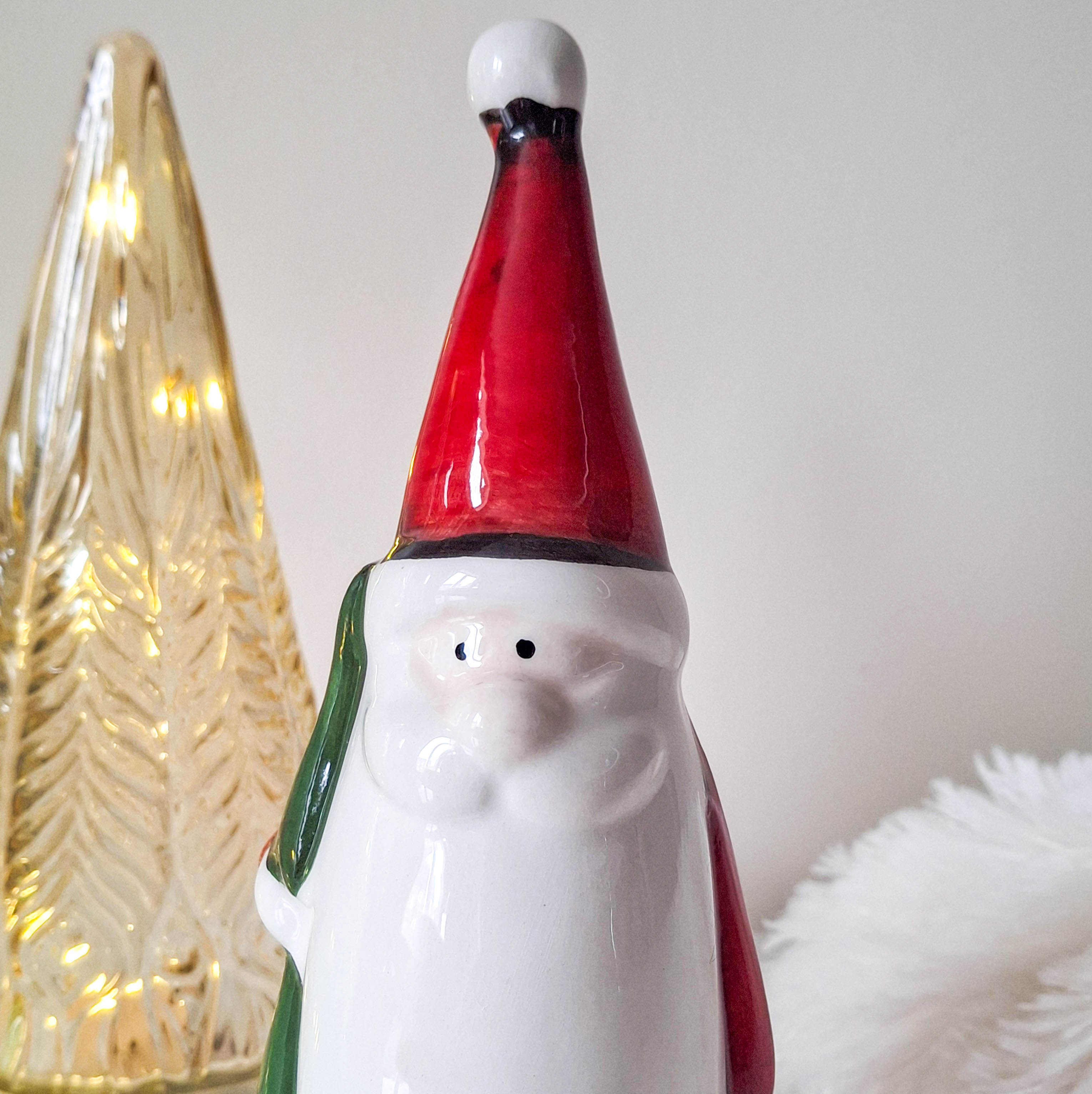 Red Santa Holding Christmas Tree