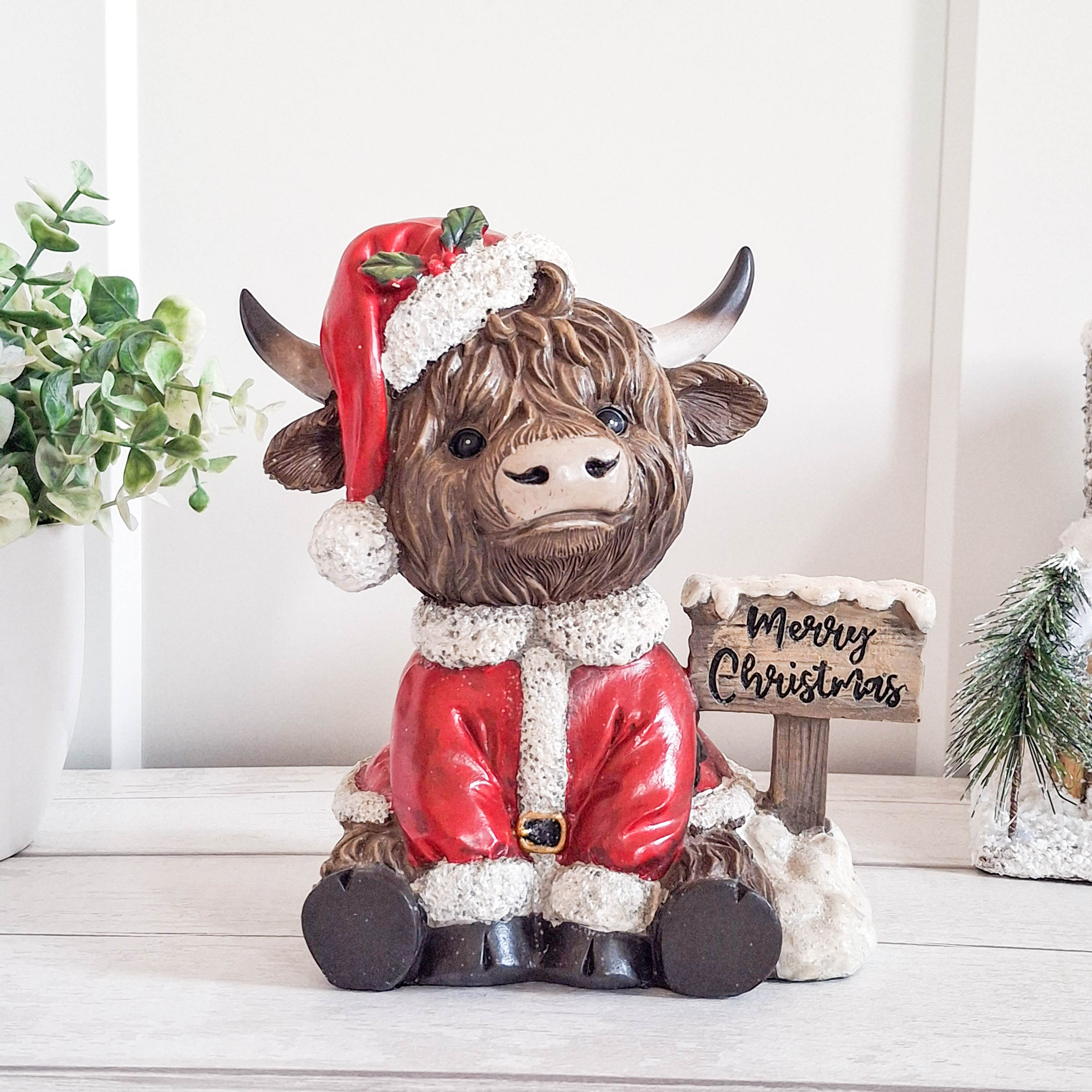 Highland Cow with Merry Christmas Sign