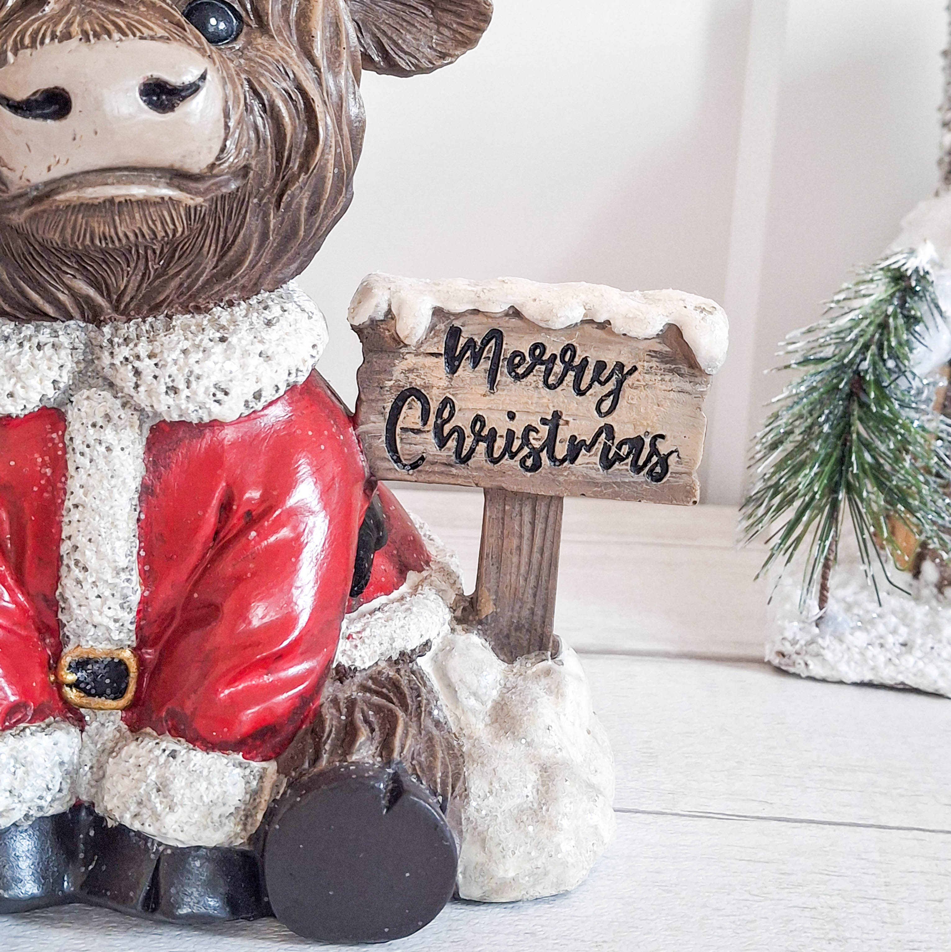 Highland Cow with Merry Christmas Sign
