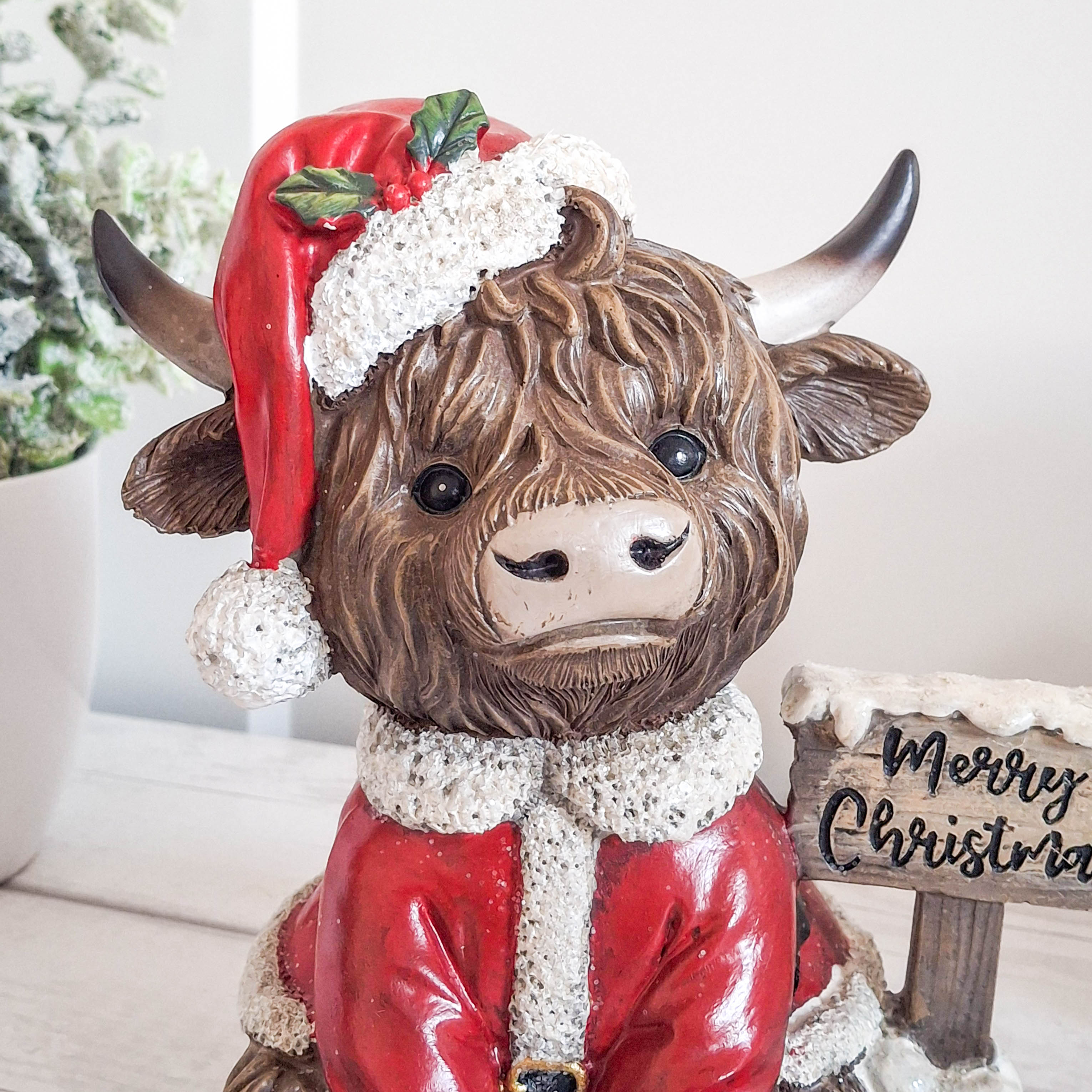 Highland Cow with Merry Christmas Sign