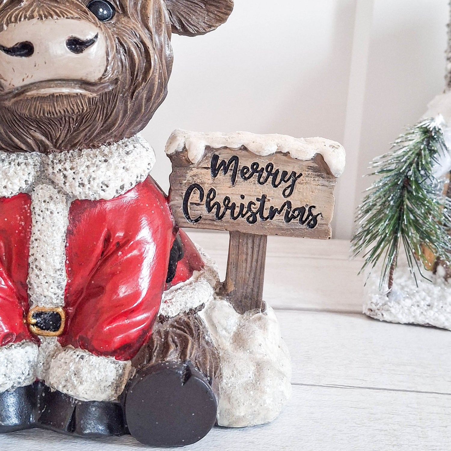 Highland Cow with Merry Christmas Sign