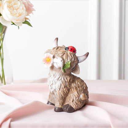 Sitting Highland Cow with Flower